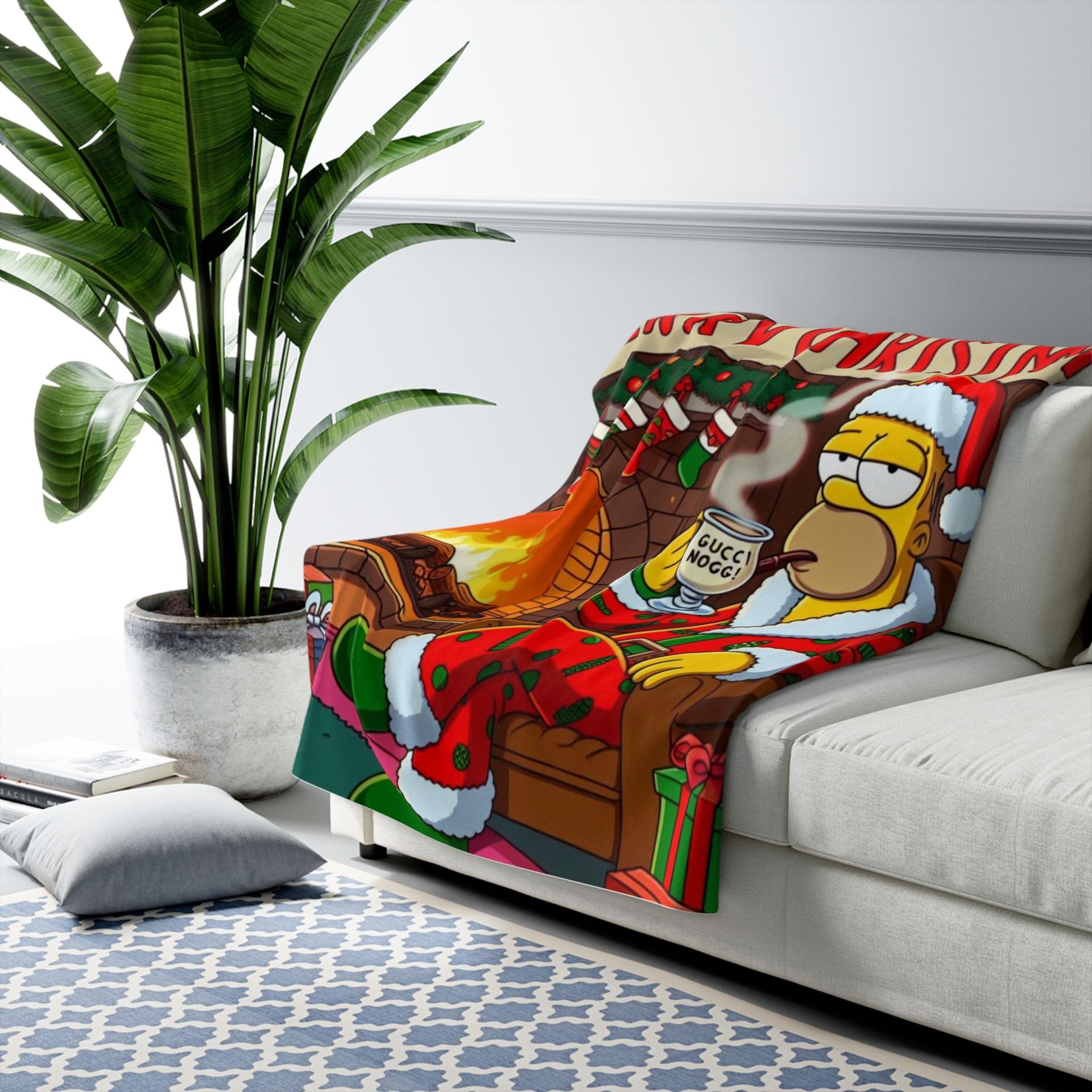 Sofa with a colorful cartoon Christmas blanket beside a large green plant in a white room.